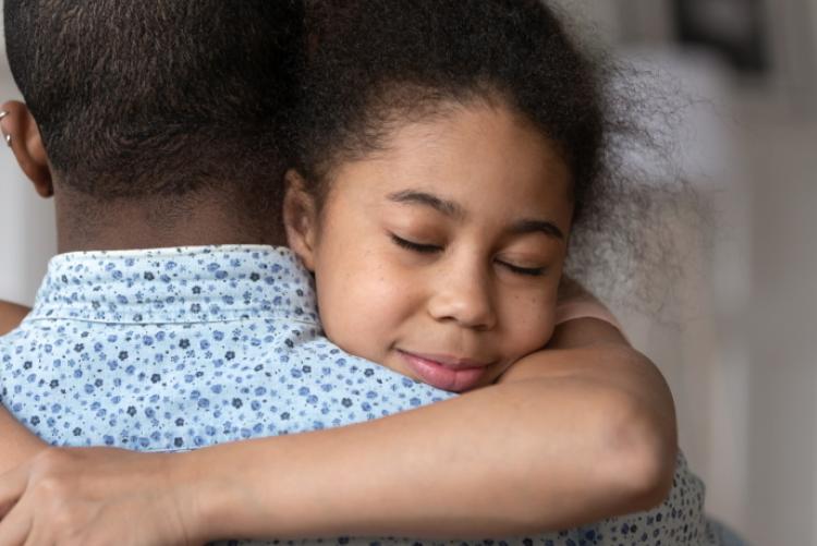 Child hugging a parent