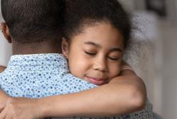 Child hugging a parent
